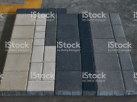 Concrete Paving slabs factory. Tiles piled in pallets, close-up, selective focus. Warehouse paving slabs in the factory for its production
